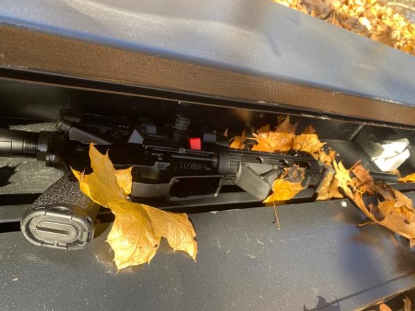 Photo of rifle in gun case taken by Joel  Kuszai. It is seen close up on the ground with leaves scattered a<em></em>bout