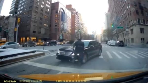 The moment Sahara Dula, driving the wrong way on Park Avenue, allegedly strikes an NYPD officer and sends him flying Wednesday 1/17 afternoon.