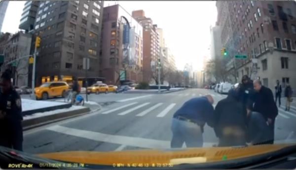 The moment Sahara Dula, driving the wrong way on Park Avenue, allegedly strikes an NYPD officer and sends him flying Wednesday 1/17 afternoon..