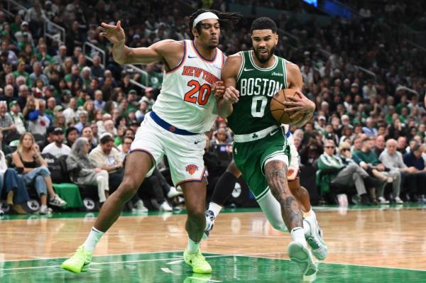 Jayson Tatum, who scored a game-high 37 points, drives on Jericho Sims during the Knicks' 132-109 opening-night loss to the Celtics on Oct. 22, 2024.