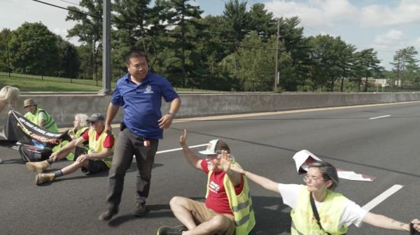 One man ran between the protestors tearing their signs and banners from their hands and shouting that he had to work