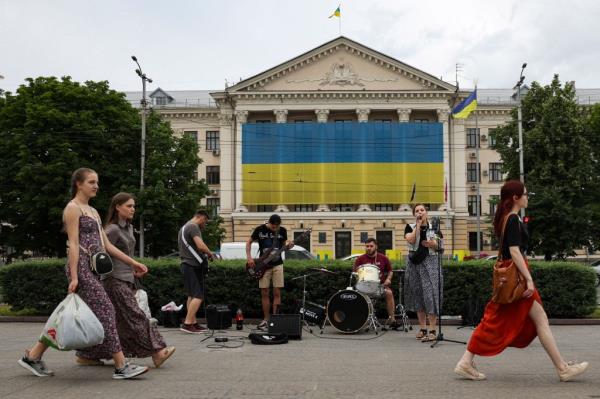 Zaporizhzhia residents were pictured walking past a band playing music on June 10, 2023.
