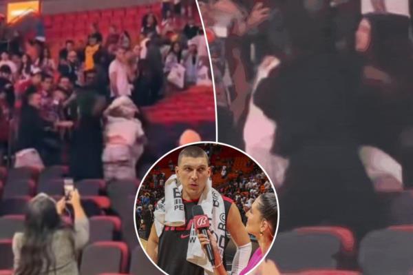 热火队的球迷在激烈的争吵中分散了泰勒·赫罗的注意力