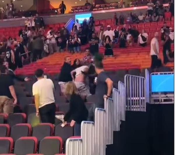 Fans deliver blows during a fight in the stands during the Heat's preseason game on Tuesday.