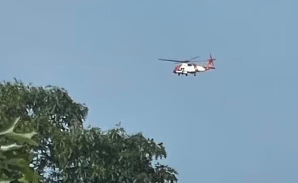 A Coast Guard Helicopter flies over Edgartown Great Pond during the search for the missing paddleboarder