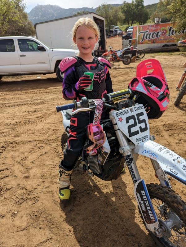 Brooke Carlton smiles on bike. 
