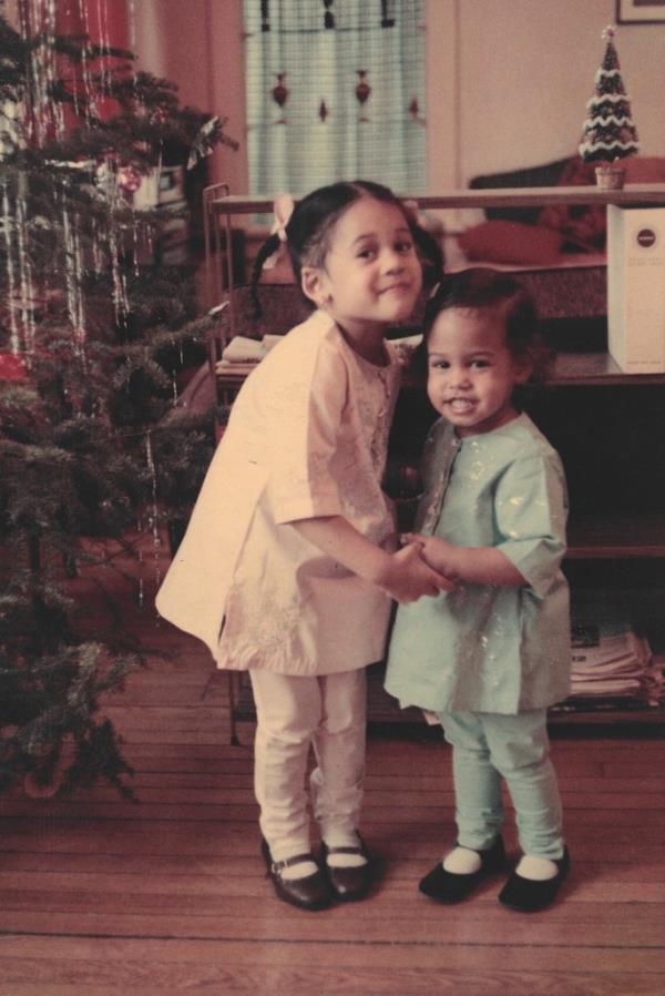 Kamala Harris and. younger sister Maya Harris in front of a Christmas tree in 1968.