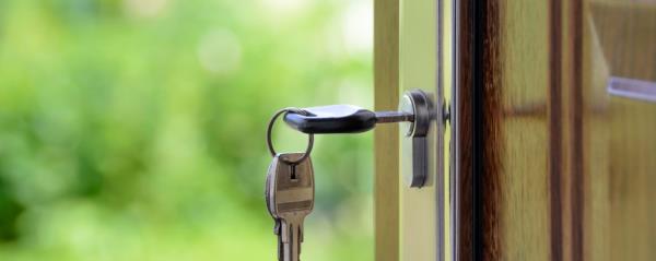 Image of a key inserted into the lock on a door