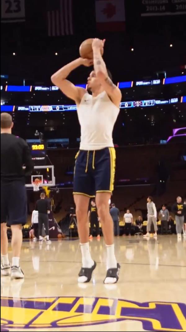 Michael Porter Jr. warms up for the Nuggets in slides during his pregame shooting time.