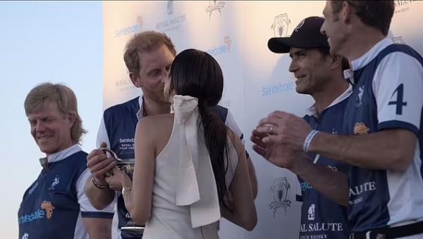 Prince Harry and Meghan Markle kiss in the 