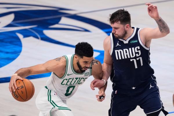 Jayson Tatum of the Boston Celtics driving to the basket against Luka Do<em></em>ncic of the Dallas Mavericks during the NBA finals game