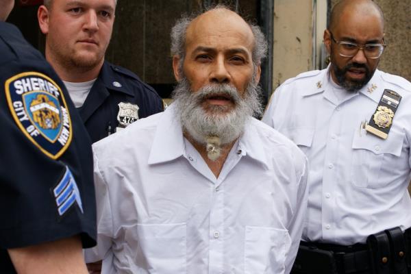 Jose Alba exiting the Tombs and entering NYC Sheriff's Department custody on July 7, 2022, accompanied by police officers.