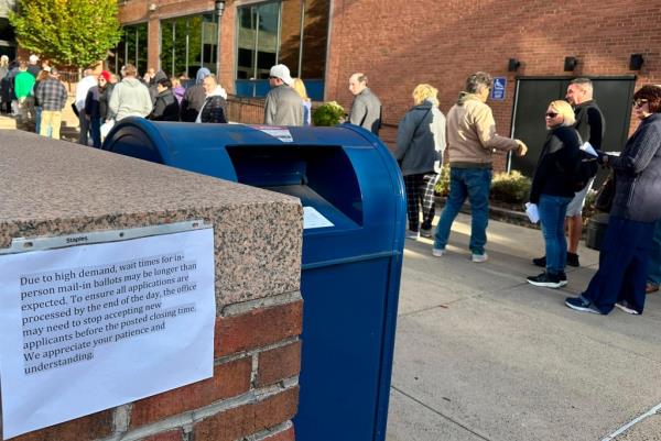 People lining up outside the Bucks County government building in Doylestown, Pa., to apply for mail-in ballots on the last day of request, Oct. 29, 2024