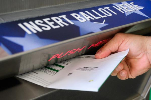 A voter depositing a ballot into a drop box in Doylestown, Pennsylvania during the 2024 elections