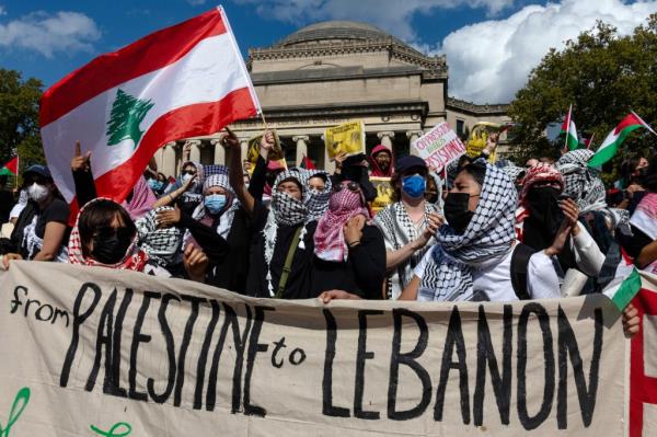 Students at Columbia University holding a banner that reads 