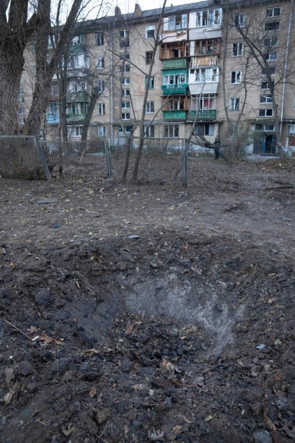 A crater left by drone fragments in an apartment building yard following a Russian drone attack in Kyiv, Ukraine, Saturday, Nov. 25, 2023. Russia launched its most intense drone attack on Ukraine since the beginning of its full-scale invasion on Saturday morning, military officials said. (AP Photo/Efrem Lukatsky)
