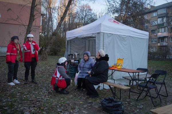 Paramedics give psychological aid to residents of a damaged apartment building following a Russian drone attack in Kyiv, Ukraine, Saturday, Nov. 25, 2023. Russia launched its most intense drone attack on Ukraine since the beginning of its full-scale invasion on Saturday morning, military officials said. (AP Photo/Efrem Lukatsky)