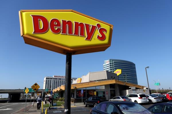 Denny's restaurant sign posted in front of building in Emeryville, California, indicating forthcoming quarterly earnings report.