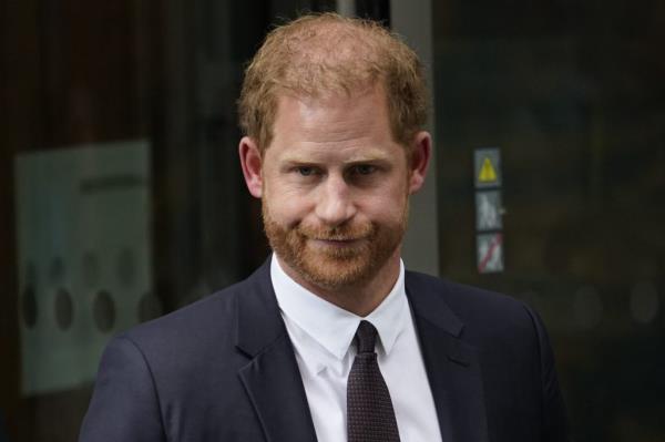 Prince Harry, Duke of Sussex, in a suit, leaving the court after giving evidence, surrounded by people, London, June 6, 2023.