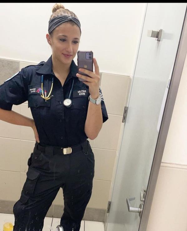 Julia Fatum takes a mirror selfie in her EMT uniform