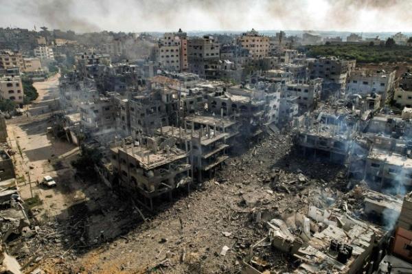 TOPSHOT - This picture taken on October 11, 2023 shows an aerial view of buildings destroyed by Israeli air strikes in the Jabalia camp for Palestinian refugees in Gaza City. Israel declared war on Hamas on October 8 following a shock land, air and sea assault by the Gaza-ba<em></em>sed Islamists. The death toll from the shock cross-border assault by Hamas militants rose to 1,200, making it the deadliest attack in the country's 75-year history, while Gaza officials reported more than 900 people killed as Israel pounded the territory with air strikes. (Photo by Yahya HASSOUNA / AFP) (Photo by YAHYA HASSOUNA/AFP via Getty Images)