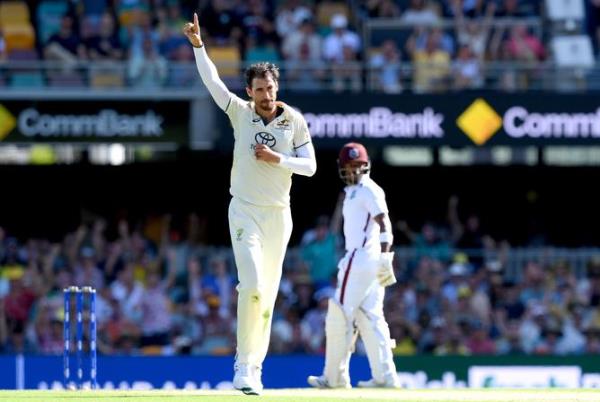 BRISBANE, AUSTRALIA - JANUARY 25: Mitchell Starc of Australia celebrates taking the wicket of Justin Greaves of the West Indies during day one of the Second Test match in the series between Australia and West Indies at The Gabba on January 25, 2024 in Brisbane, Australia. (Photo by Bradley Kanaris/Getty Images)