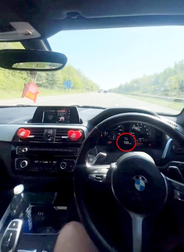 Video shows driver's dashboard registering 123 mph as Iqbal drives one handed.
