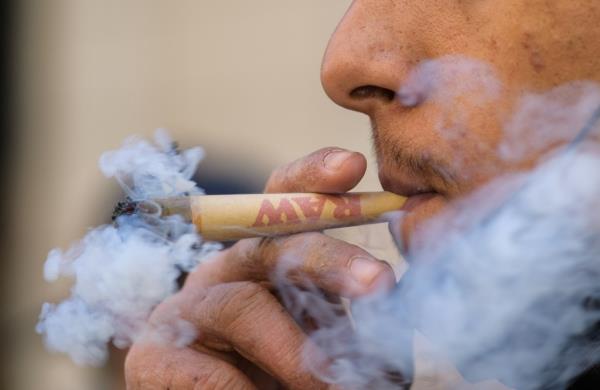 An activist smokes marijuana during the annual NYC Cannabis Parade & Rally in support of the legalization of marijuana for recreatio<em></em>nal and medical use on May 1, 2021 in New York City.