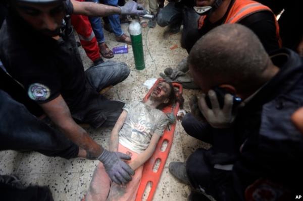 Palestinians rescue a wounded girl from under the rubble of a destroyed building following an Israeli airstrike in Khan Younis refugee camp, southern Gaza Strip, Nov. 7, 2023.