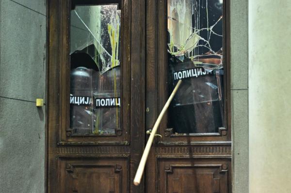 A wooden object is thrown towards police officers guarding the entrance to the Belgrade's city council building during a demo<em></em>nstration in Belgrade, on December 24, 2023