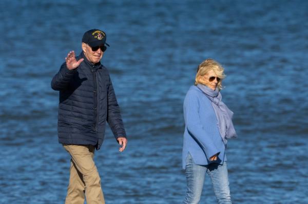 President Joe Biden and first lady Jill Biden walk along the beach in Rehoboth Beach, Del., Sunday, Oct 22, 2023. 