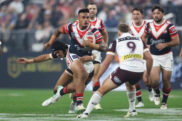 Spencer Leniu of the Roosters runs the ball.