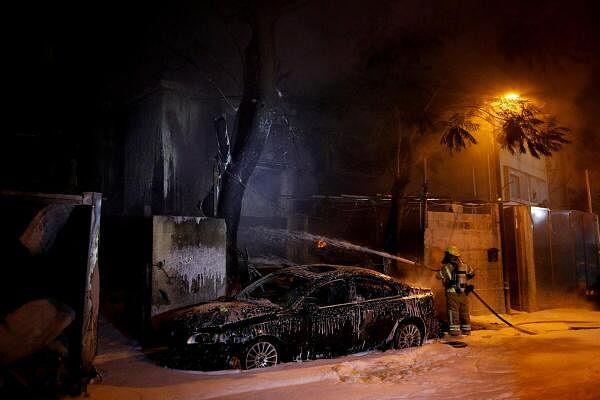 A firefighter works at the scene wher<em></em>e a projectile fell after projectiles were launched from Lebanon, amid o<em></em>ngoing hostilities between Hezbollah and Israel, in Kiryat Ata, northern Israel.
