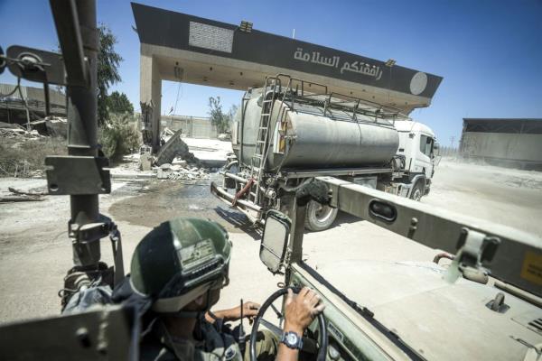 Israeli soldiers drive on the Palestinian side of Kerem Shalom crossing during a ground operation on July 3. The Israeli military invited reporters for a tour of Rafah, wher<em></em>e the military has been operating since May 6.