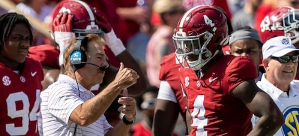 Alabama head coach Nick Saban talks with quarterback Jalen Milroe