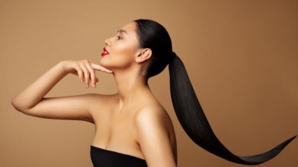 Beauty Model Profile. Young Woman with long Po<em></em>nytail Hair. Women Face Side view over beige background. Lady with Red Lipstick and Black Straight Tail Hairstyle