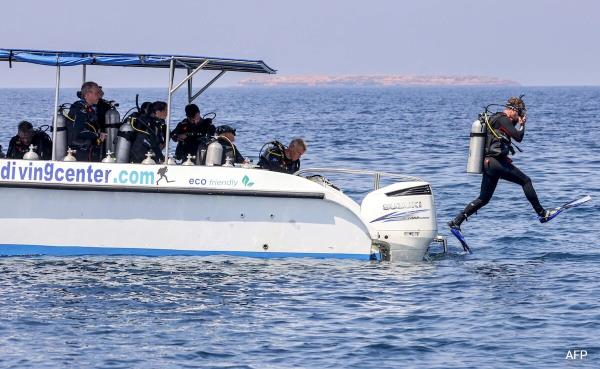 A volunteer diver jumps into the water during a campaign to remove fishing nets from coral reefs at Omans Dimaniyat islands on October 4, 2024. A volunteer diver jumps into the water during a campaign to remove fishing nets from coral reefs at Omans Dimaniyat islands on October 4, 2024.