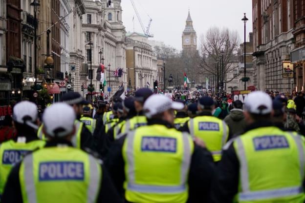 Police are seen at the rear of a march in London, wher<em></em>e demo<em></em>nstrators were showing support for Palestinian people in Gaza.
