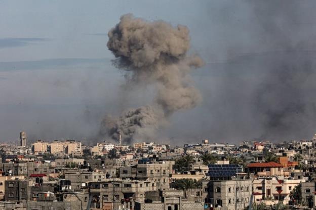 A large cloud of smoke rises above Khan Younis, in the Gaza Strip, amid bombardment by Israeli forces.