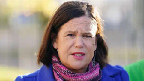 PA Media Mary Lou McDo<em></em>nald wearing blue jacket and pink scarf