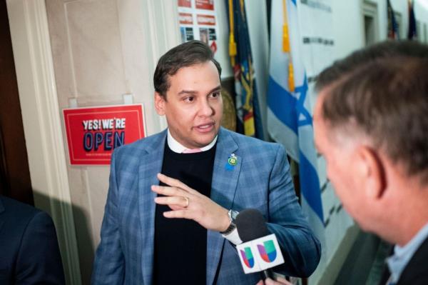 Rep. George Santos speaks with a reporter outside his office ahead of debate on his expulsion from Co<em></em>ngress in the Lo<em></em>ngworth House Office Building in Washington, DC on  Nov. 30, 2023.